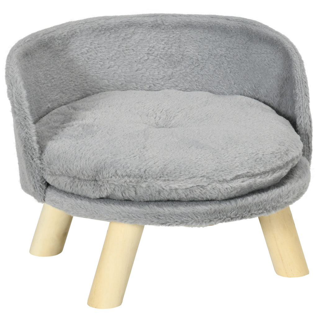 A round dog sofa with plush fabric and wood construction, featuring a grey plush fabric cushion and natural wood legs.