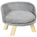 A round dog sofa with plush fabric and wood construction, featuring a grey plush fabric cushion and natural wood legs.